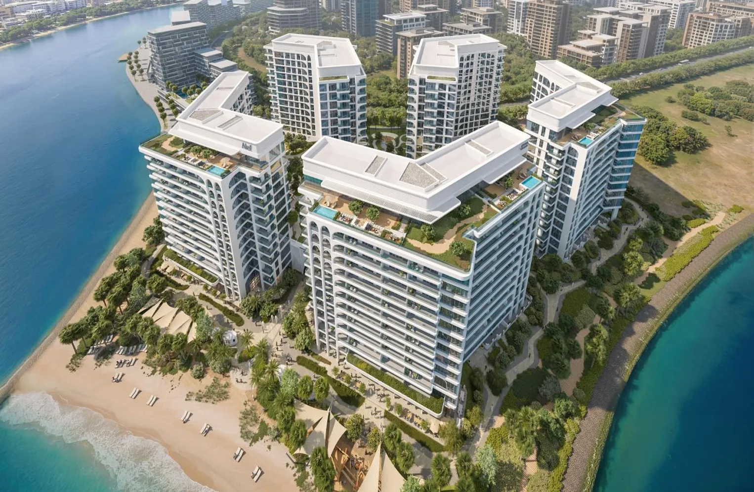 Aerial view of Seefa’s contemporary residential buildings, landscaped gardens and beachfront surrounded by turquoise water